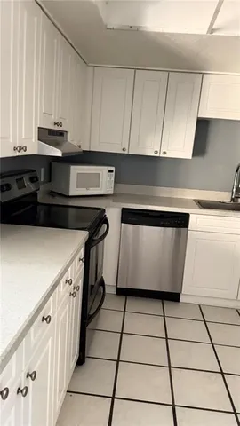 a kitchen with a sink and cabinets