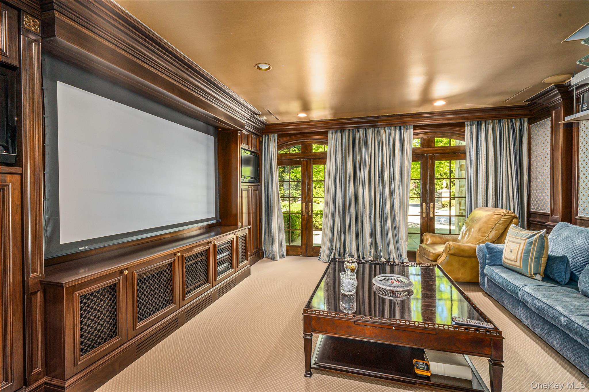 167 Brookville Road Glen Head, NY 11545 - Photo 11 of 31 Cinema room with motorized projector screen, recessed lighting, french doors, carpet, speakers throughout