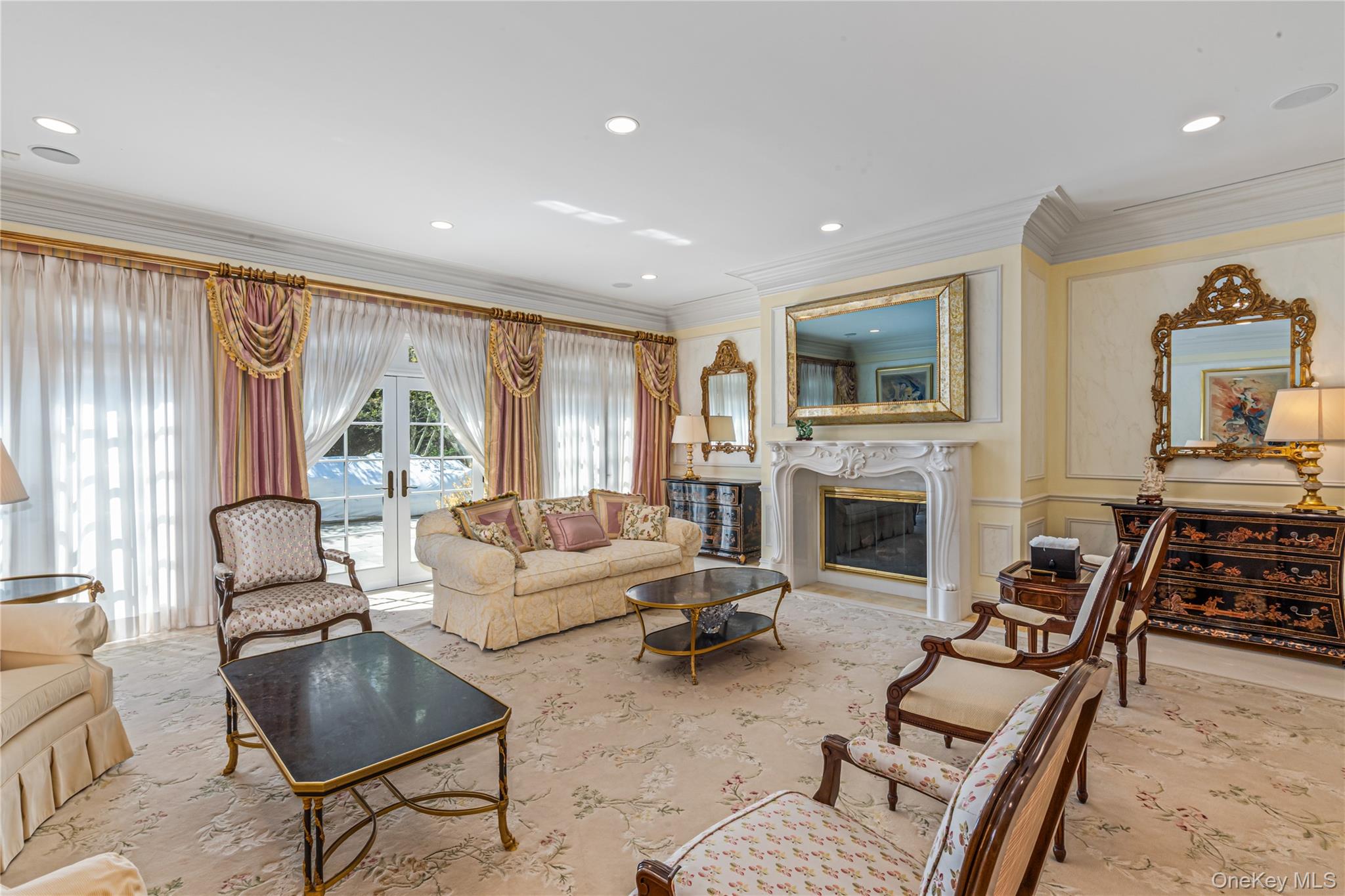 167 Brookville Road Glen Head, NY 11545 - Photo 7 of 31 Expansive Living room featuring crown molding, gas fireplace, french doors leading to slate patio, recessed lighting and speakers throughout