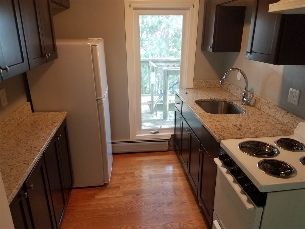 a kitchen with a sink stove and refrigerator