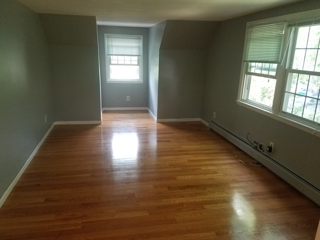 10 Andria Road, Unit 2 Boston, MA 02136 - Photo 2 of 5 wooden floor in an empty room with a window