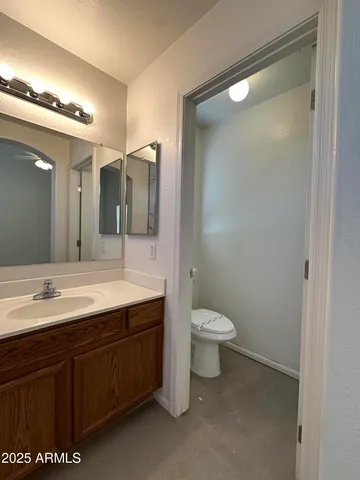 a bathroom with a double vanity sink mirror and toilet