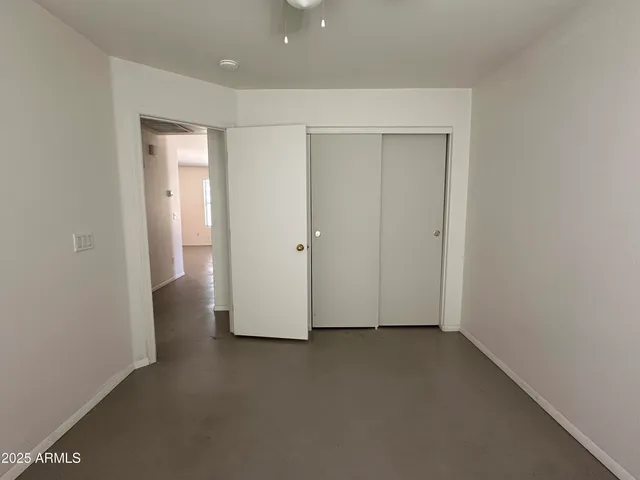 an empty room with closet area