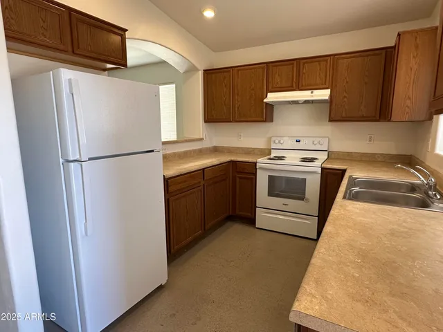 a white refrigerator freezer sitting inside of a kitchen