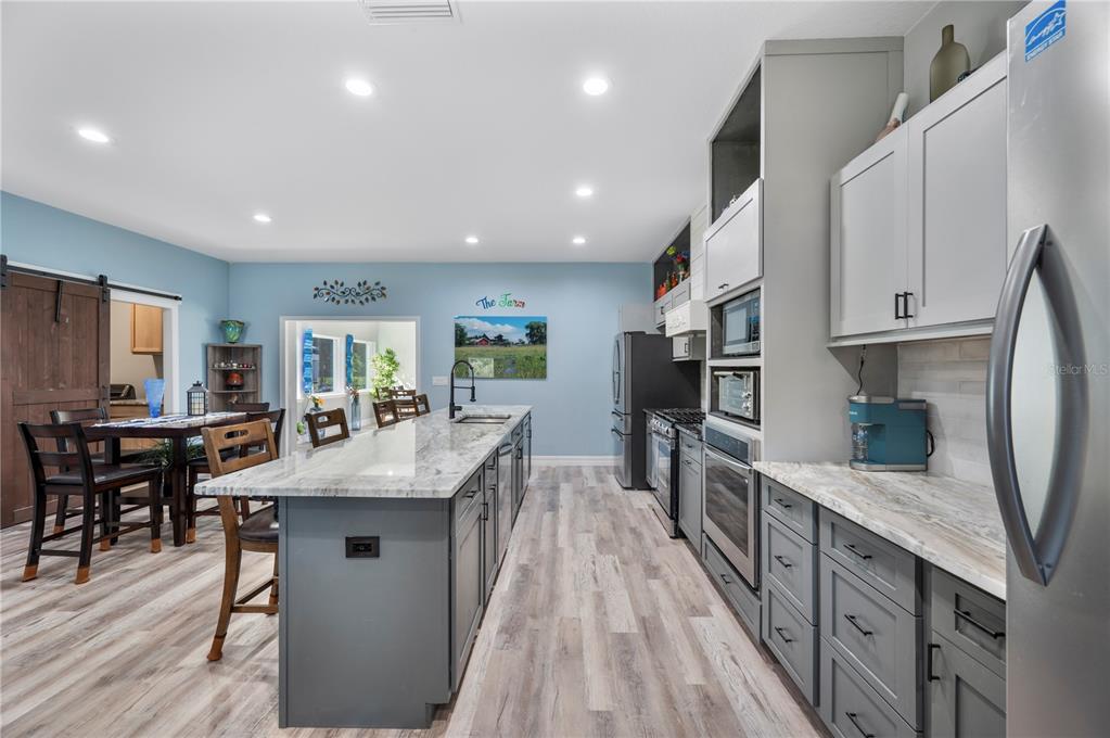 2525 Ranchland Acres Road Lakeland, FL 33809 - Photo 17 of 68 a kitchen with stainless steel appliances granite countertop lots of counter top space and wooden floor
