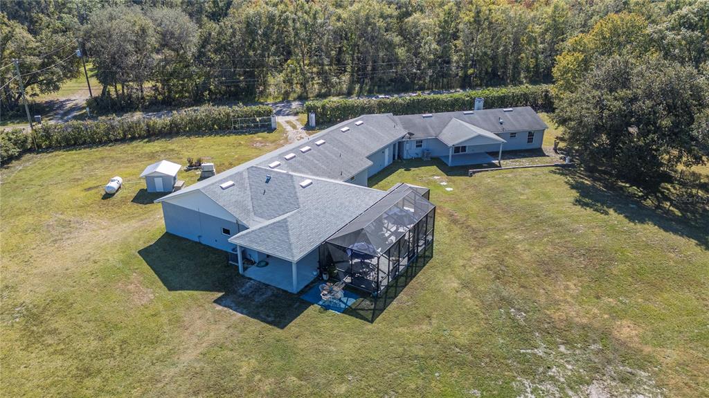 2525 Ranchland Acres Road Lakeland, FL 33809 - Photo 2 of 68 an aerial view of a house with swimming pool and a yard