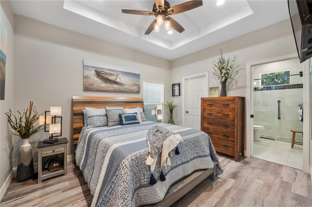 2525 Ranchland Acres Road Lakeland, FL 33809 - Photo 26 of 68 a bedroom with a bed and a chandelier