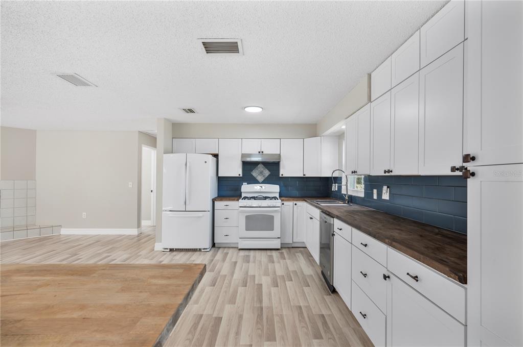 2525 Ranchland Acres Road Lakeland, FL 33809 - Photo 47 of 68 a kitchen with white cabinets and white appliances