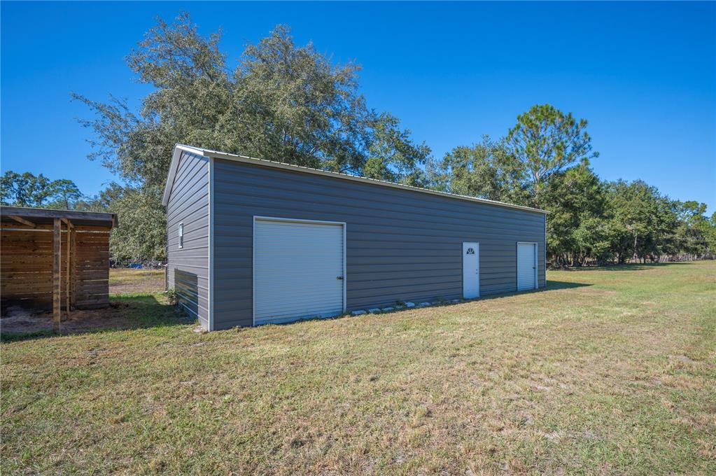 2525 Ranchland Acres Road Lakeland, FL 33809 - Photo 7 of 68 a front view of a house with a yard and garage
