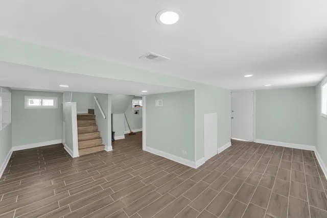 wooden floor in an empty room with a bathroom