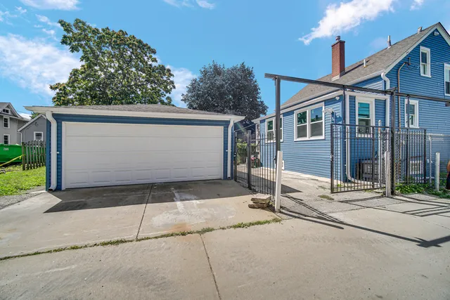 a wooden bench sitting in front of a house