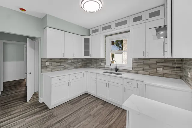 a kitchen with granite countertop white cabinets and white appliances