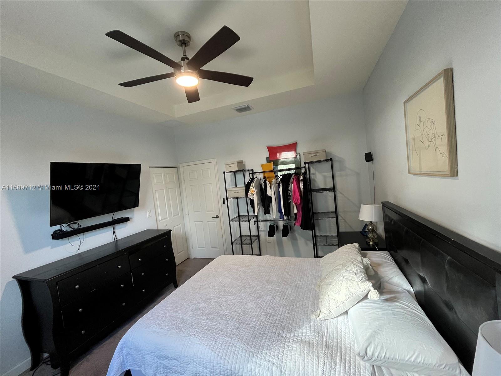 Hialeah Hialeah, FL 33018 - Photo 13 of 23 a bedroom with a bed and a flat tv screen on dresser