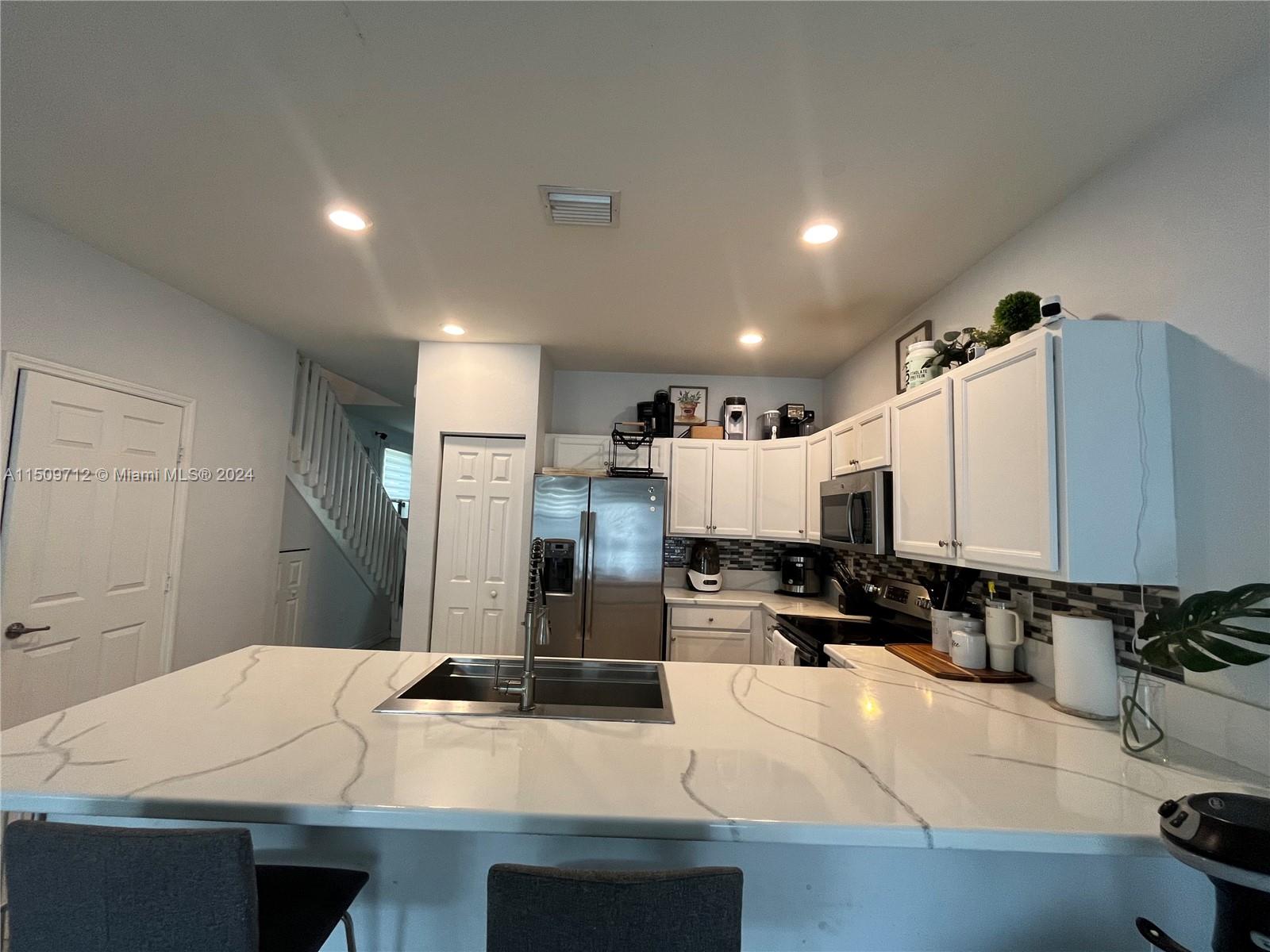 Hialeah Hialeah, FL 33018 - Photo 5 of 23 a kitchen with kitchen island a counter top space a sink and appliances