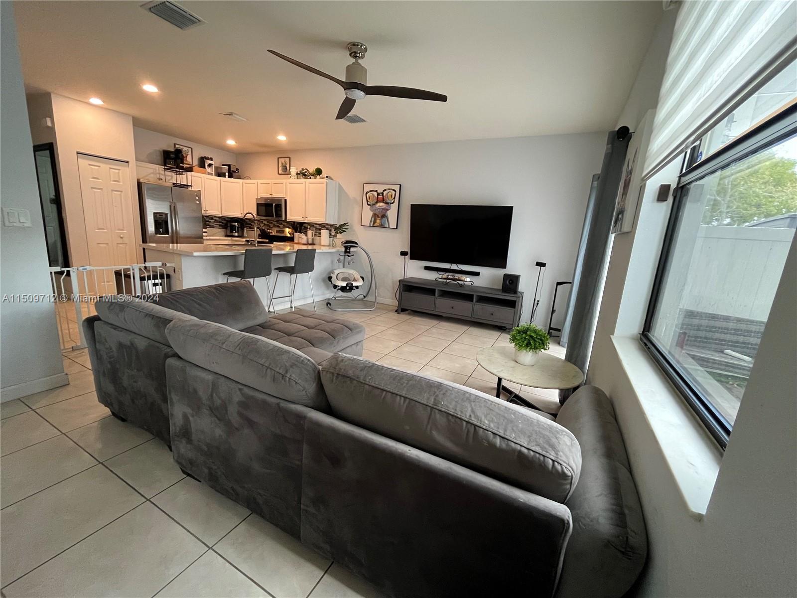 Hialeah Hialeah, FL 33018 - Photo 8 of 23 a living room with furniture and a flat screen tv