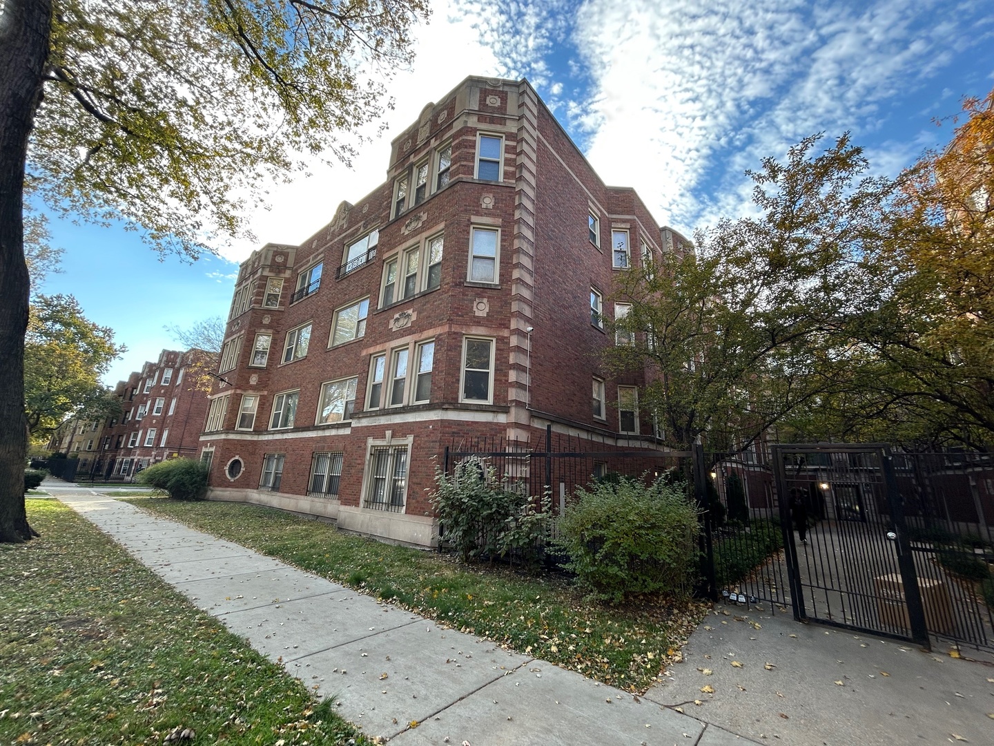 a brick building with tree in front of it