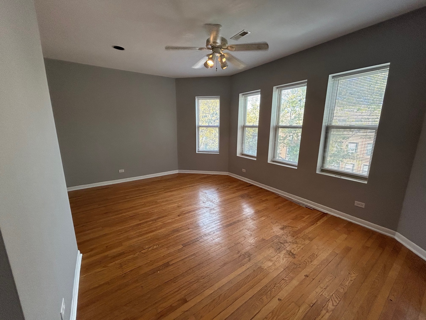8158 South Drexel Avenue, Unit 3 Chicago, IL 60619 - Photo 2 of 12 a view of an empty room with a window and wooden floor