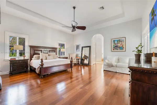 a spacious bedroom with a bed couch and a window