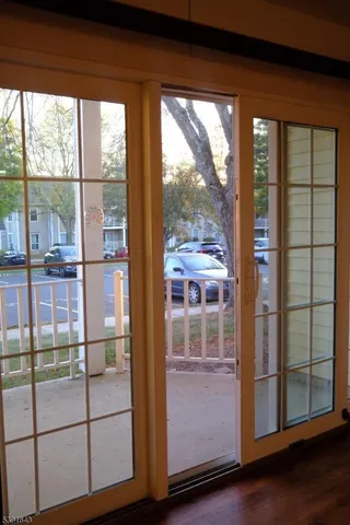 an empty room with wooden floor and door