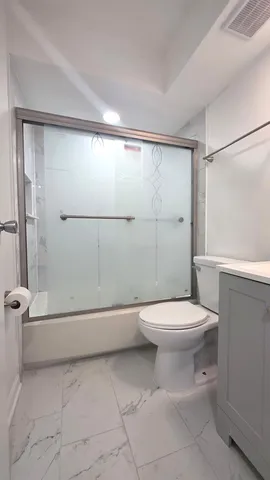 a bathroom with a toilet a sink and shower