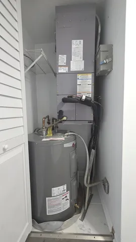 a room with water heater and utility