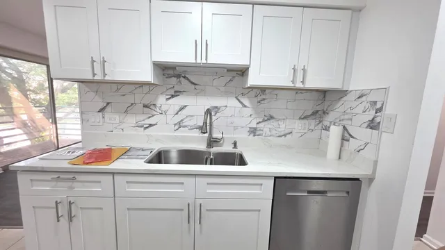 a kitchen with a sink and cabinets