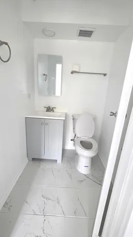 a bathroom with a sink a toilet and bathtub