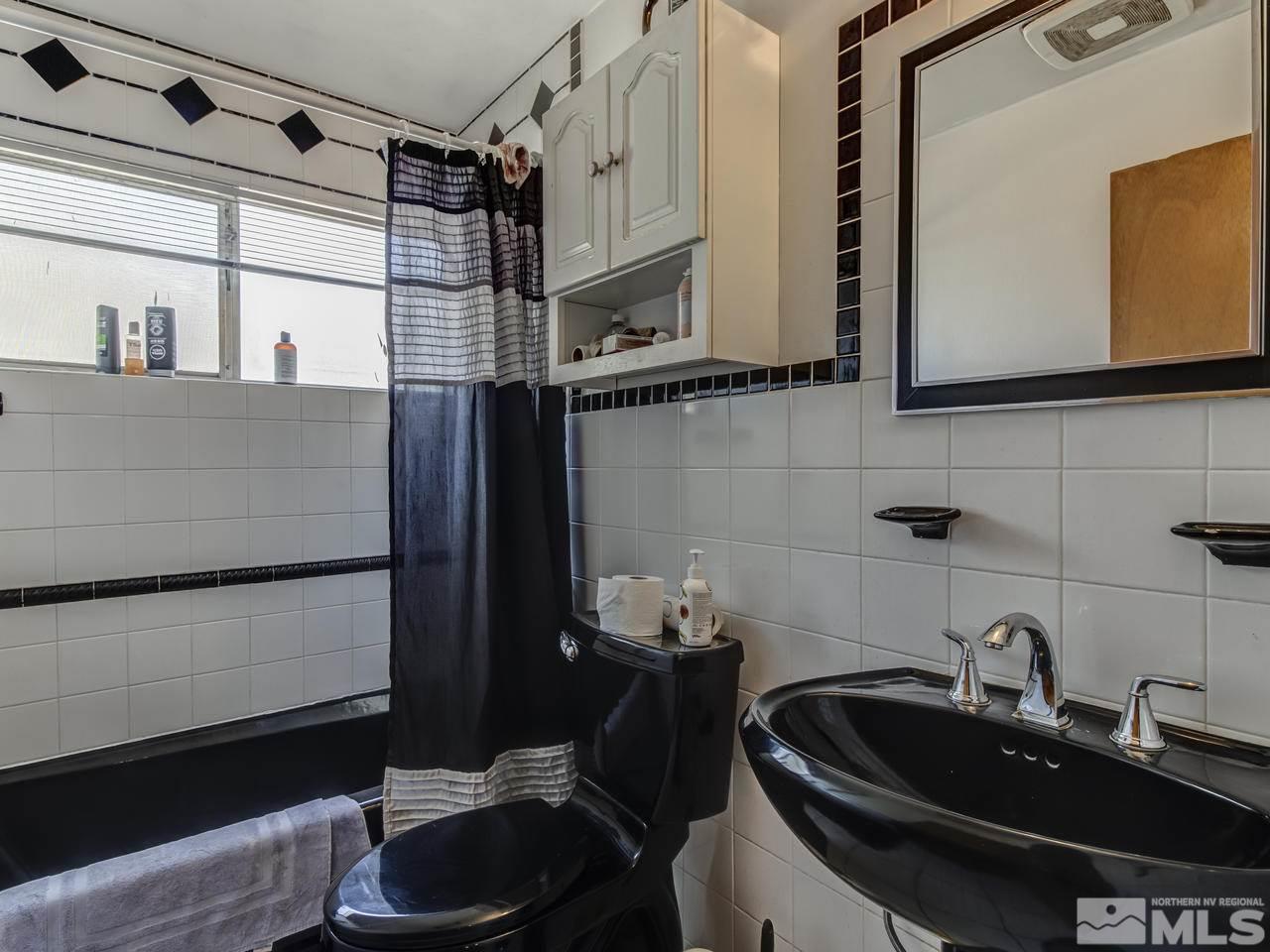 1120 Manhattan Street Reno, NV 89512 - Photo 14 of 23 a bathroom with a sink and a mirror