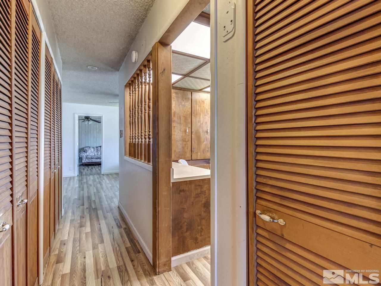 1120 Manhattan Street Reno, NV 89512 - Photo 15 of 23 a view of a hallway with wooden floor and staircase