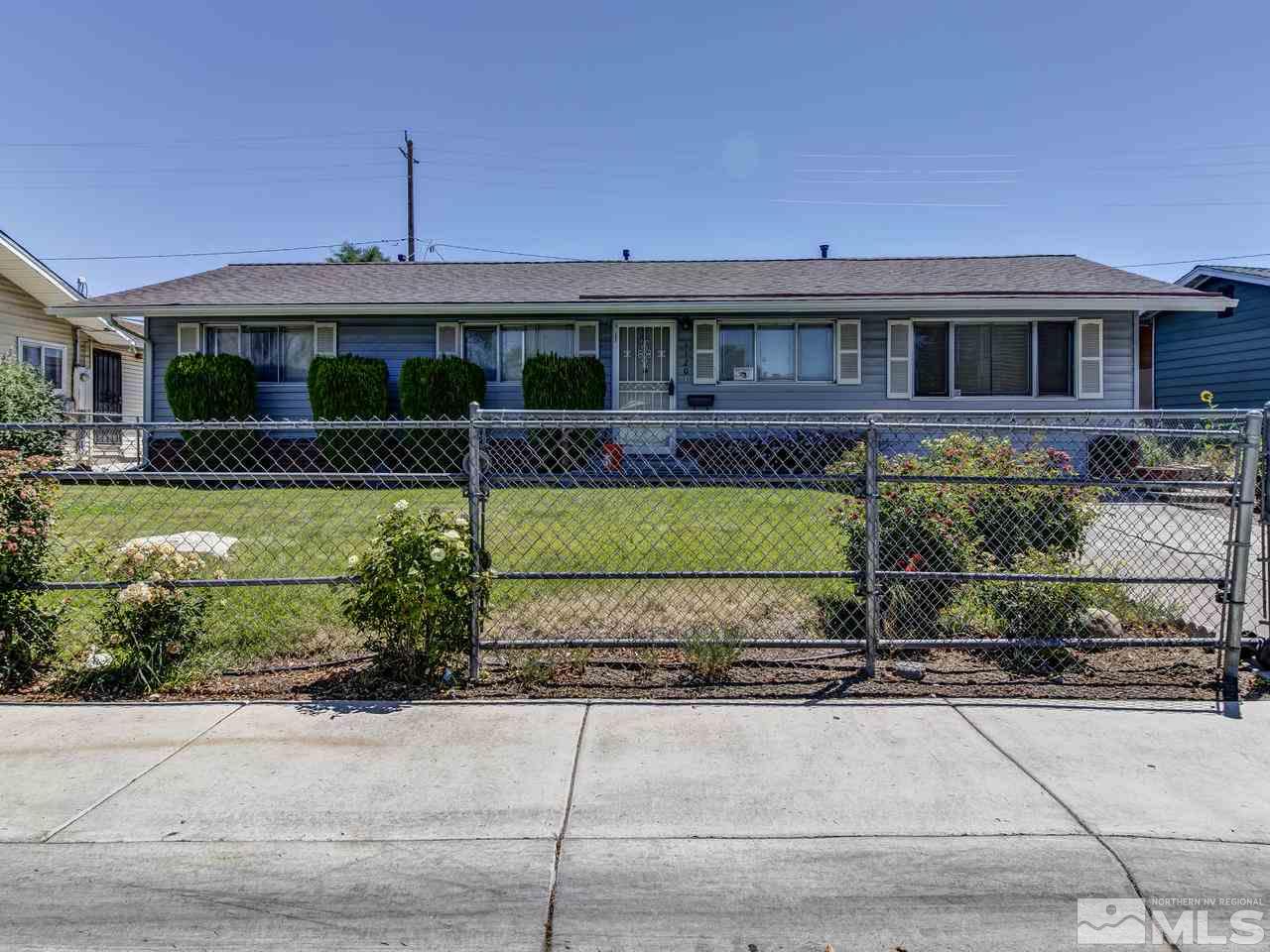 1120 Manhattan Street Reno, NV 89512 - Photo 2 of 23 a front view of a house with a garden and a yard