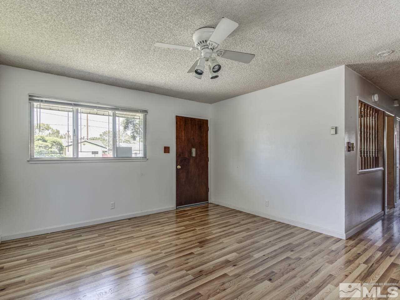 1120 Manhattan Street Reno, NV 89512 - Photo 5 of 23 a view of an empty room with wooden floor and a ceiling fan