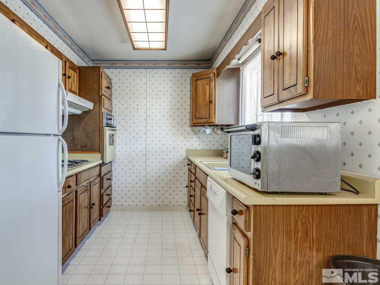 1120 Manhattan Street Reno, NV 89512 - Photo 6 of 23 a kitchen with stainless steel appliances a sink and a stove