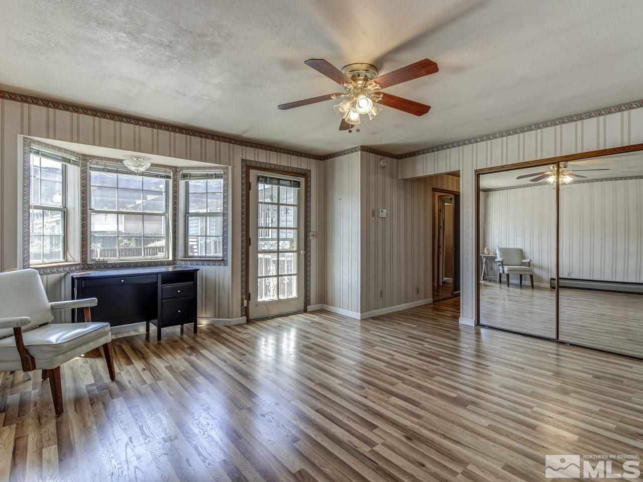 1120 Manhattan Street Reno, NV 89512 - Photo 8 of 23 an empty room with wooden floor and windows