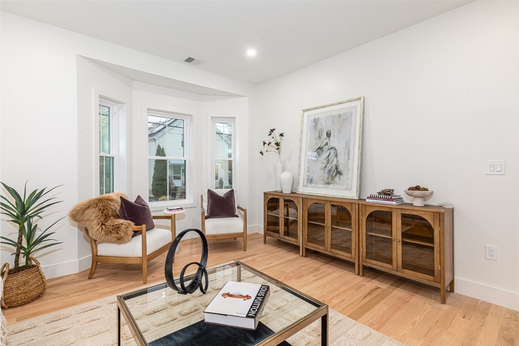 34 Waverly Place, Unit 34 Melrose, MA 02176 - Photo 20 of 39 a living room with furniture a wooden floor and potted plant