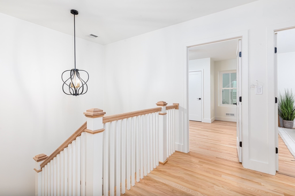 34 Waverly Place, Unit 34 Melrose, MA 02176 - Photo 21 of 39 a view of a hallway with wooden floor