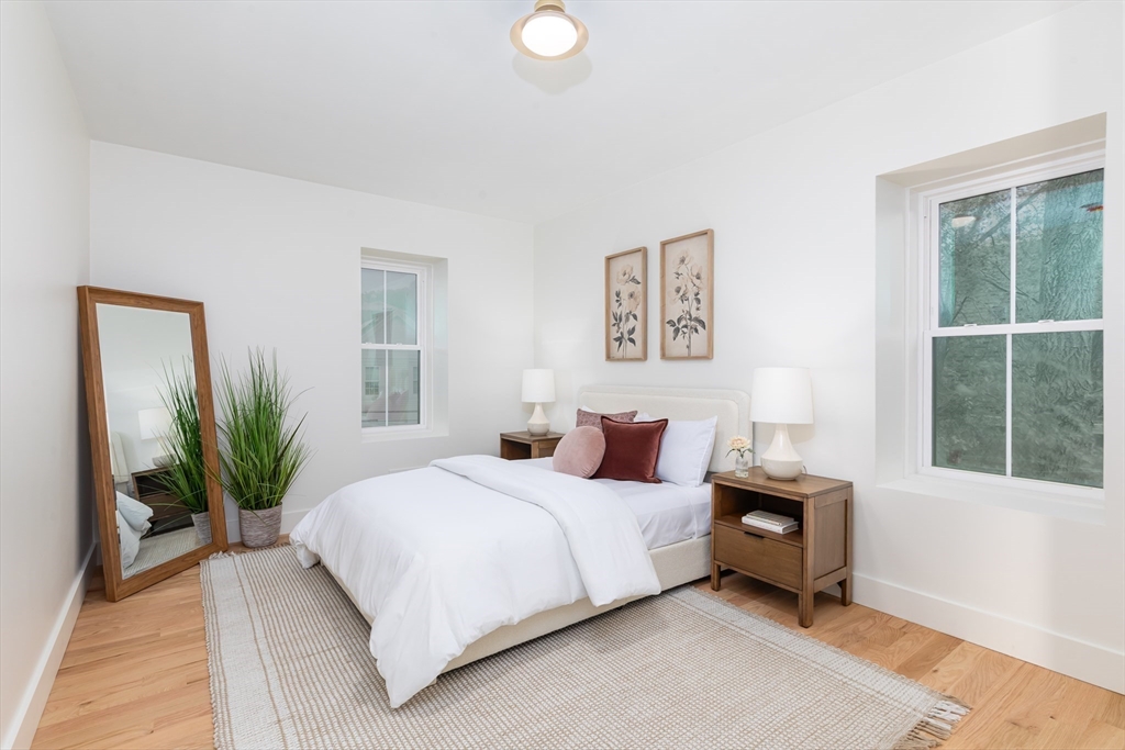 34 Waverly Place, Unit 34 Melrose, MA 02176 - Photo 23 of 39 a bedroom with bed and a potted plant next to a window