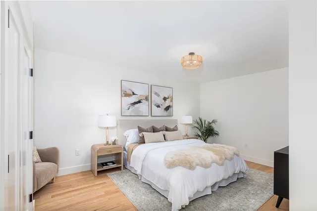 a bedroom with a bed and a mirror