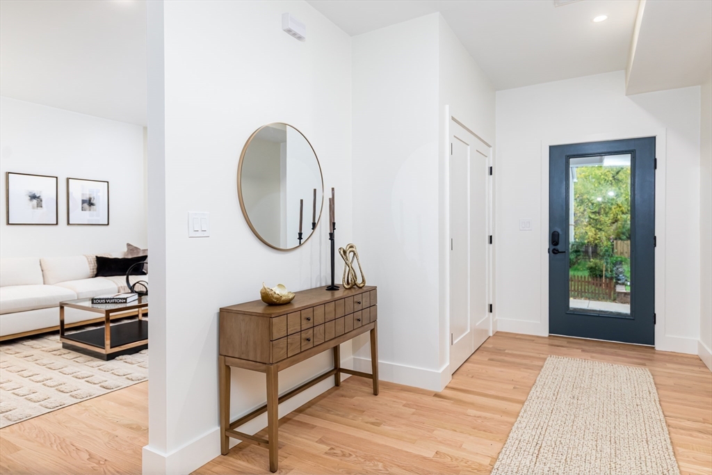 34 Waverly Place, Unit 34 Melrose, MA 02176 - Photo 3 of 39 a bedroom with a bed a mirror and a window