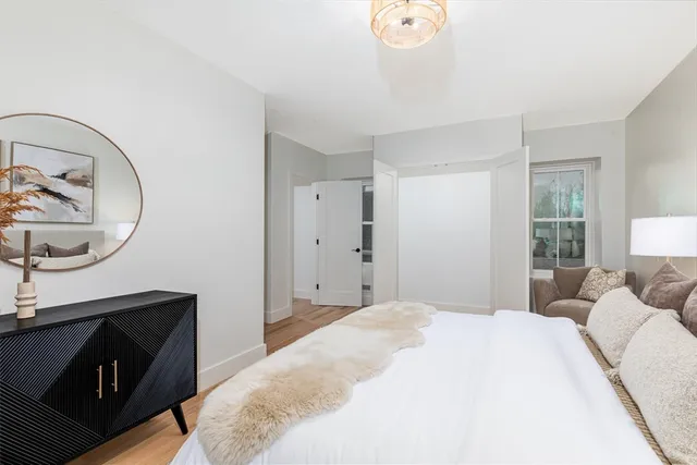 a bathroom with a granite countertop toilet a sink and a mirror
