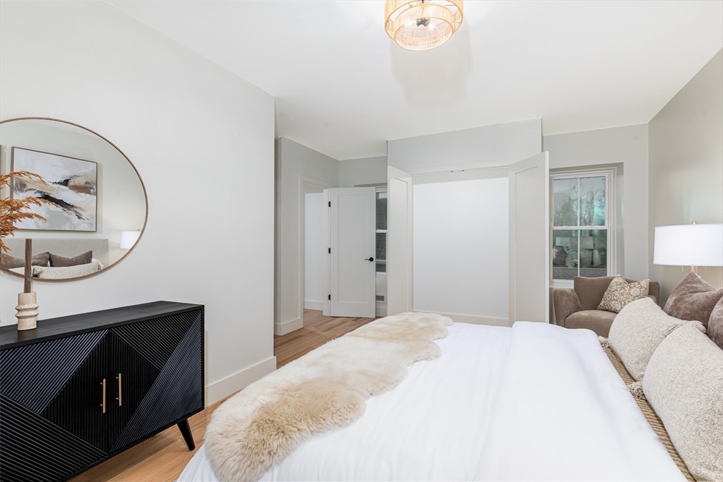 34 Waverly Place, Unit 34 Melrose, MA 02176 - Photo 31 of 39 a bedroom with a bed and a mirror