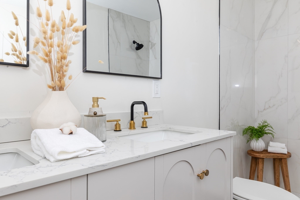 34 Waverly Place, Unit 34 Melrose, MA 02176 - Photo 35 of 39 a bathroom with a sink a toilet and mirror
