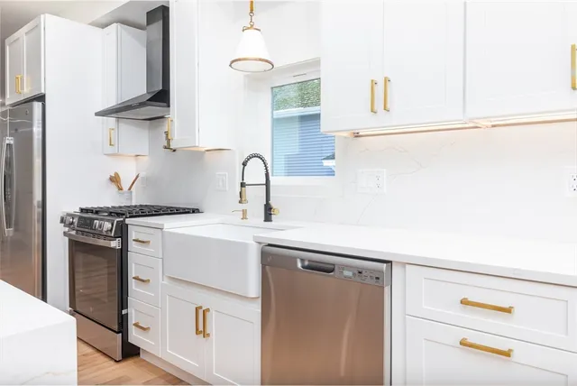 a kitchen with stainless steel appliances a sink and cabinets