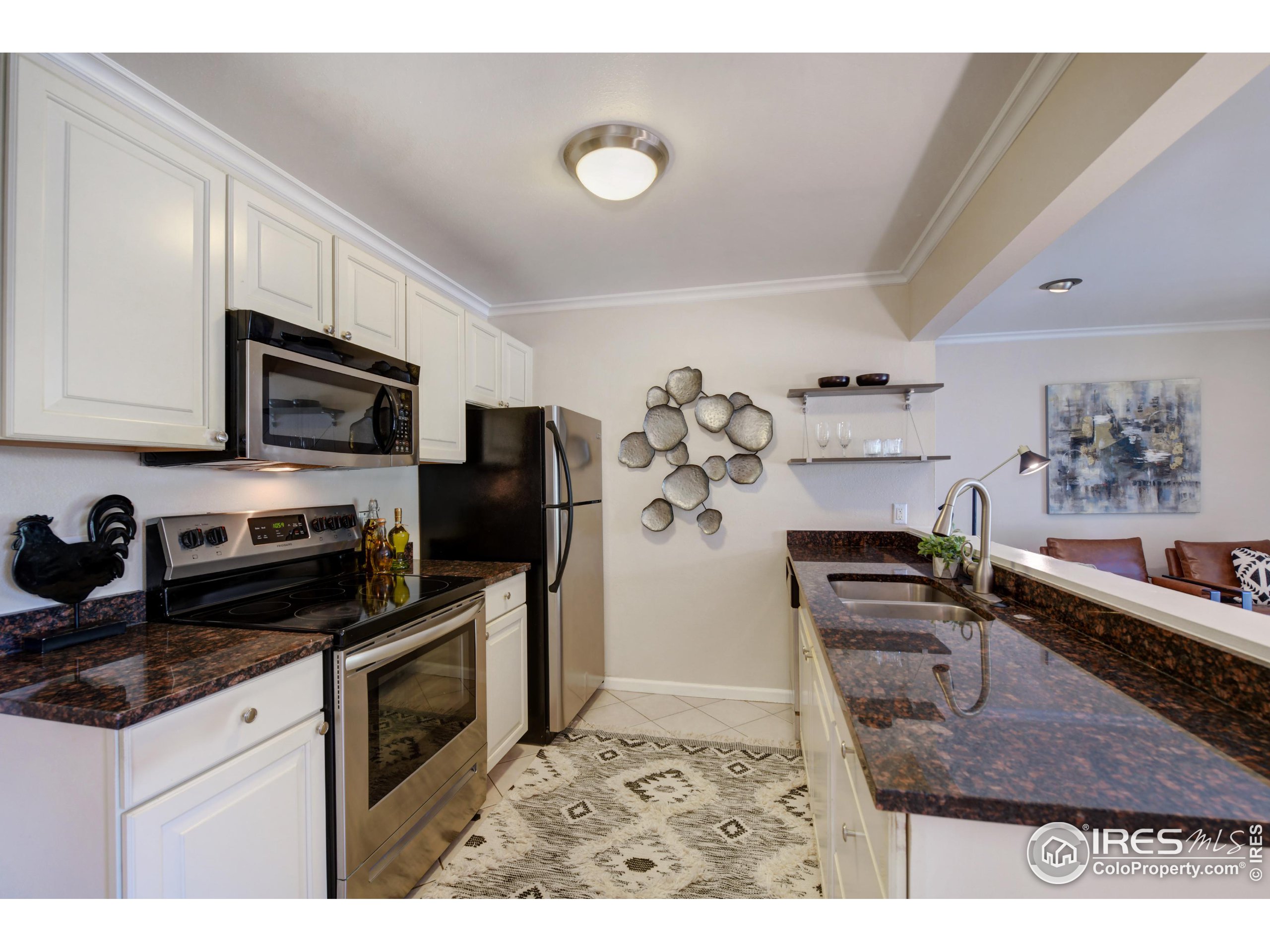 1895 Alpine Avenue, Unit E18 Boulder, CO 80304 - Photo 11 of 26 a kitchen with stainless steel appliances granite countertop a stove top oven a sink a counter space and cabinets