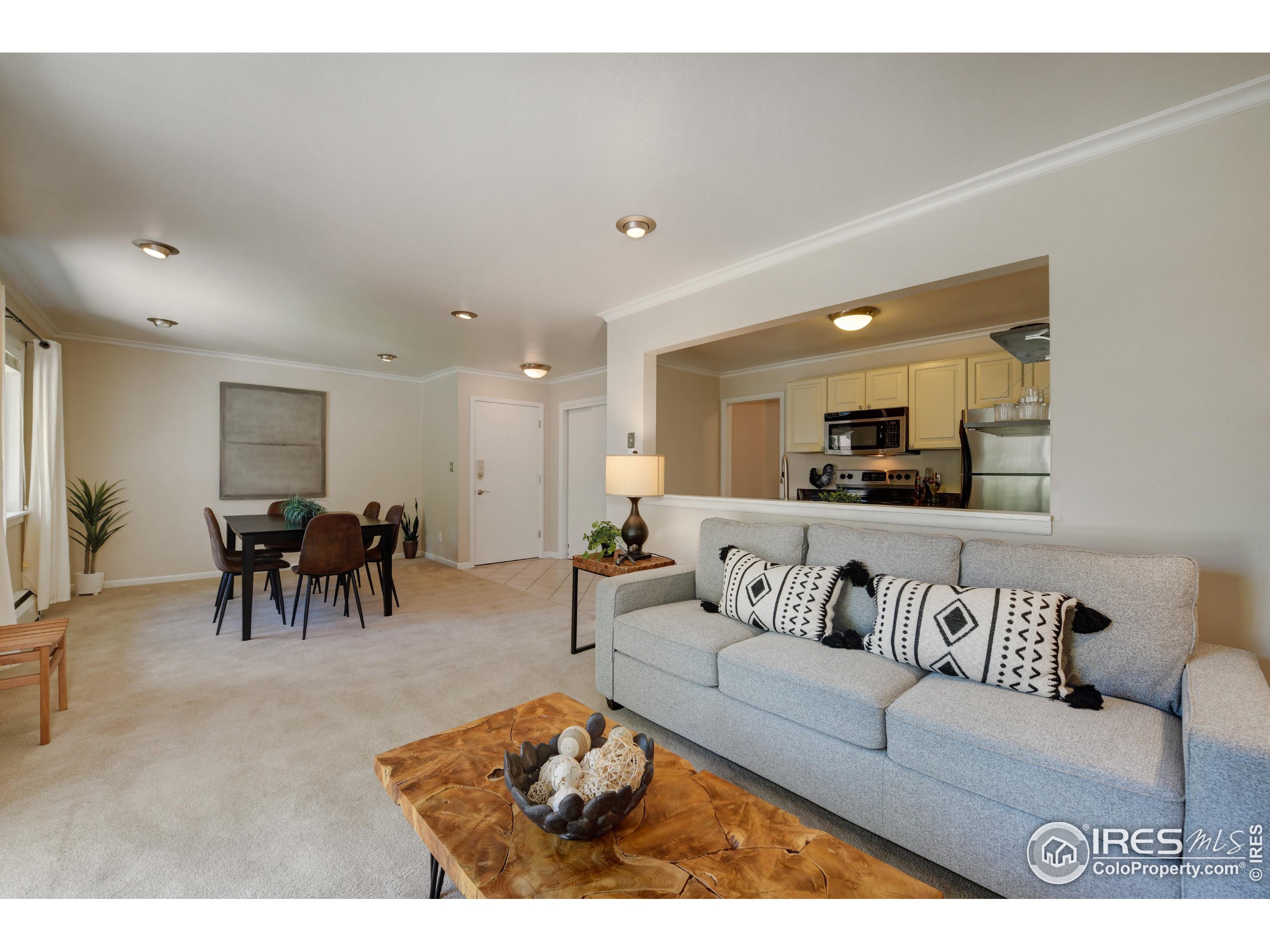 1895 Alpine Avenue, Unit E18 Boulder, CO 80304 - Photo 12 of 26 a living room with furniture and kitchen view