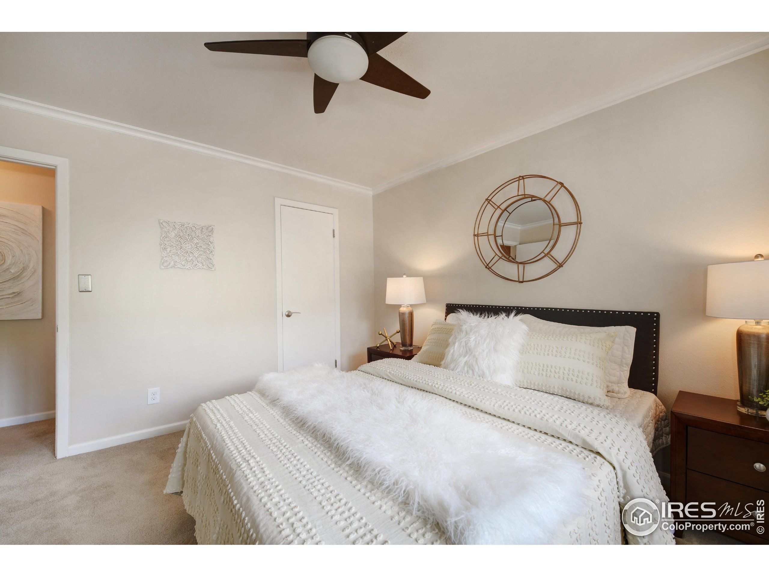 1895 Alpine Avenue, Unit E18 Boulder, CO 80304 - Photo 13 of 26 a bedroom with a bed and a chandelier