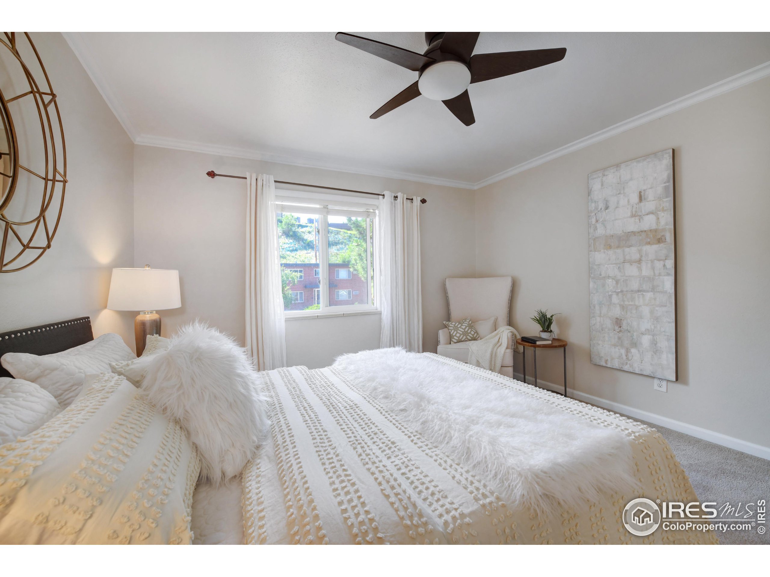 1895 Alpine Avenue, Unit E18 Boulder, CO 80304 - Photo 15 of 26 a bedroom with a bed and a lamp on dresser