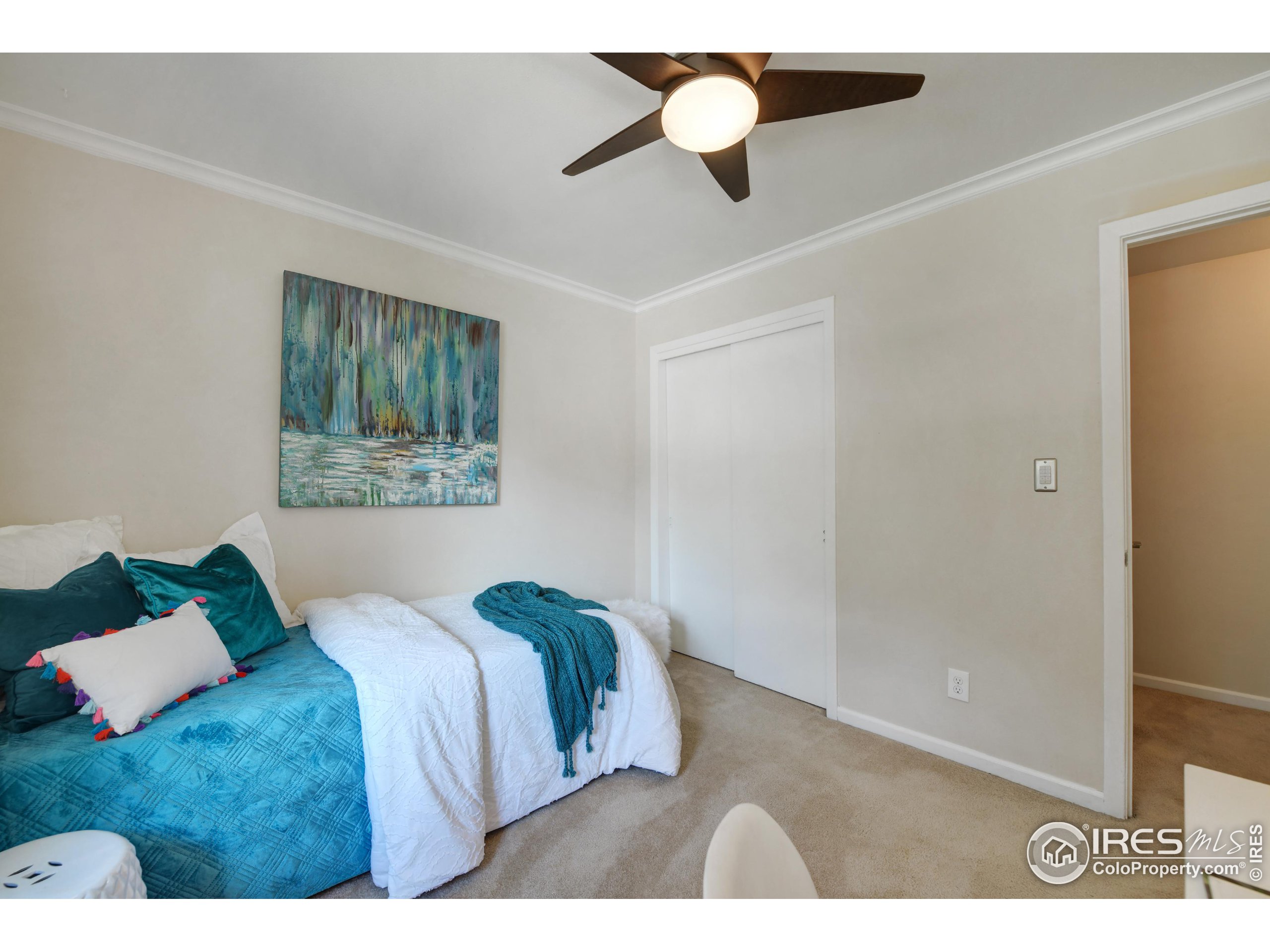 1895 Alpine Avenue, Unit E18 Boulder, CO 80304 - Photo 19 of 26 a bedroom with a bed and a painting on the wall