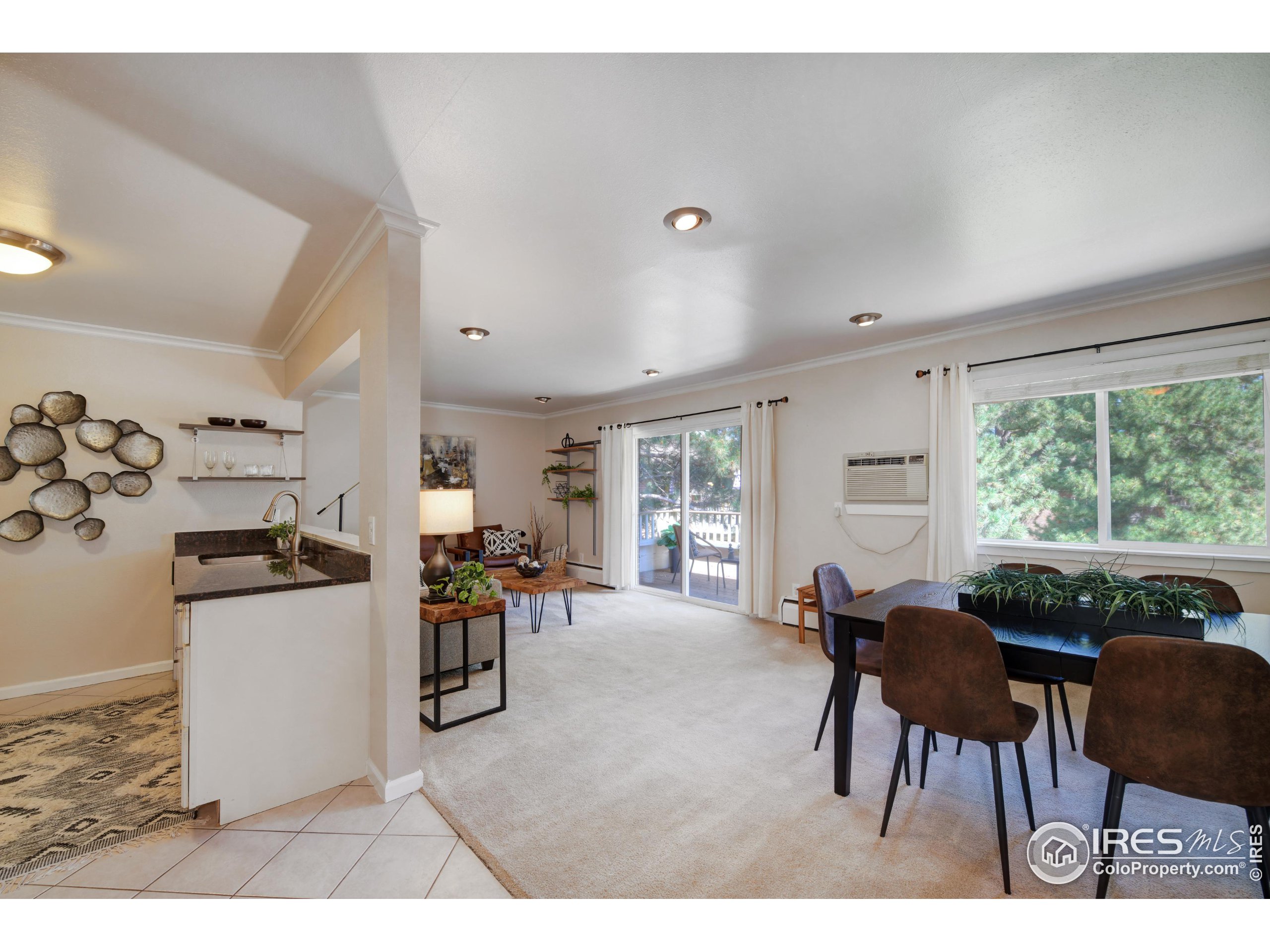 1895 Alpine Avenue, Unit E18 Boulder, CO 80304 - Photo 2 of 26 a living room with furniture and a large window