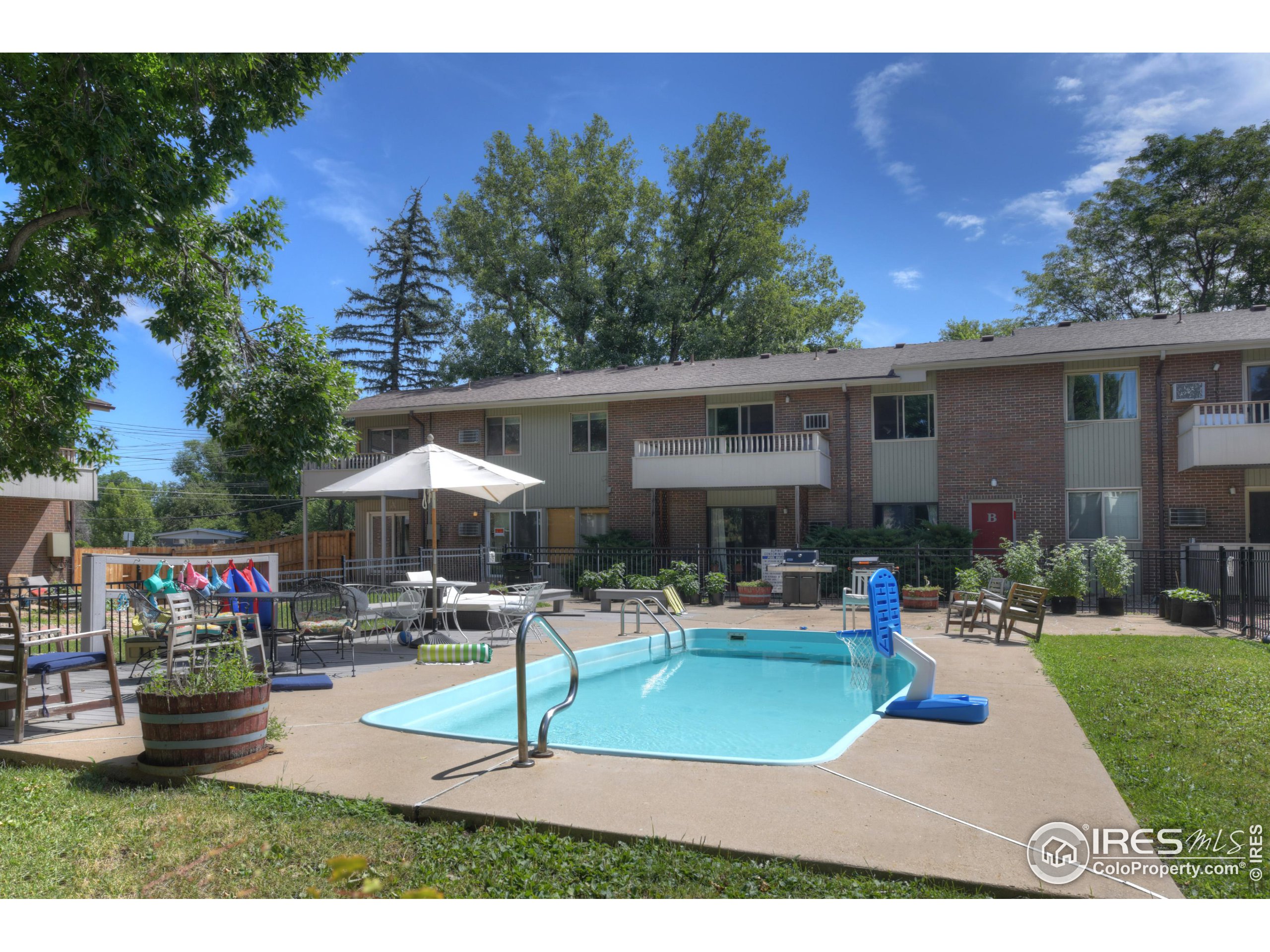 1895 Alpine Avenue, Unit E18 Boulder, CO 80304 - Photo 23 of 26 a front view of a house with garden and sitting area