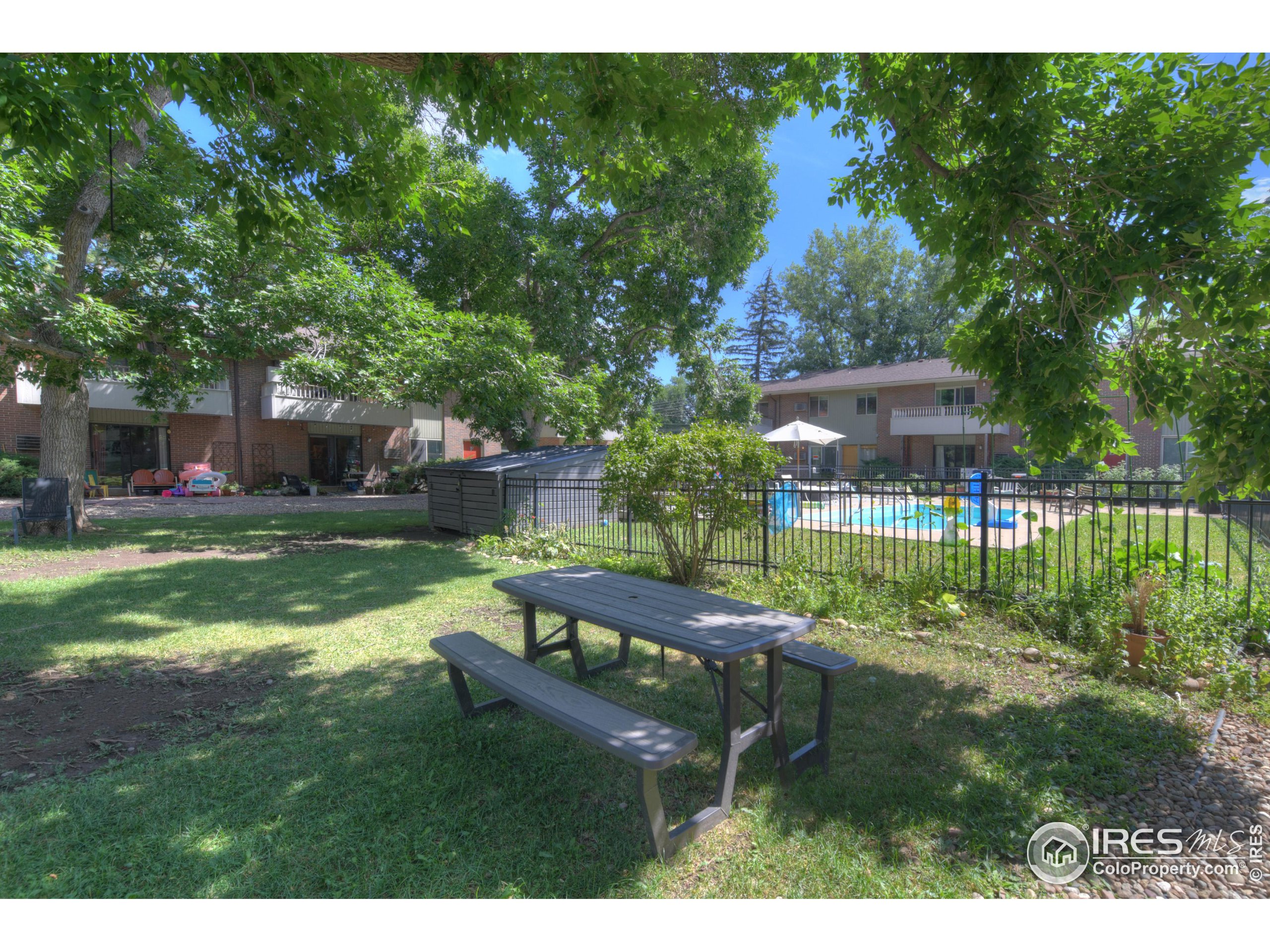1895 Alpine Avenue, Unit E18 Boulder, CO 80304 - Photo 24 of 26 a view of a backyard with a garden and sitting area